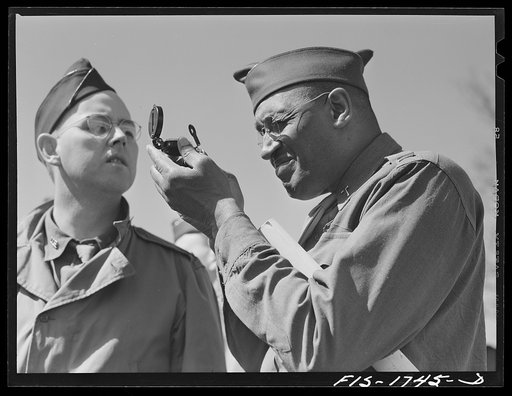 Chaplain Samuel A. Owen, right, Negro Baptist of Memphis, Tennessee, learning the use of instruments in map reading class with Chaplain E.L. Lamb, Catholic, from Kirkwood, Missouri looking on. U.S. Army chaplain school, Fort Benjamin Harrison, Indiana