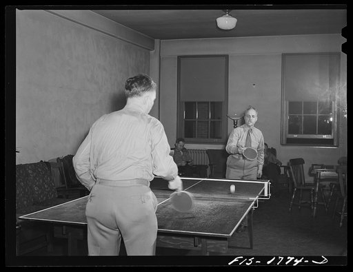 Chaplain (Major) P.M. Hickcox, and Chaplain (Major) P.L. Cronin, playing a game of ping-pong in the recreation hall of the U.S. Army chaplain school. Fort Benjamin Harrison, Indiana