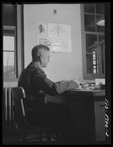 Chaplain (Lieutenant Colonel) M.D. Merchant, instructor in "morale," preparing for a class in his office. U.S. Army chaplain school, Fort Benjamin Harrison, Indiana