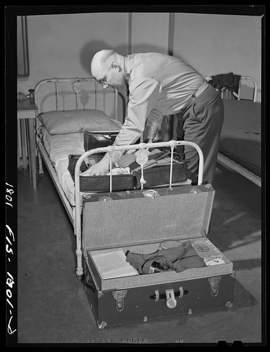 Chaplain Ralph R. Radtke, Lutheran, of Waterloo, Iowa packing his bags preparing to leave for his station. U.S. Army chaplain school, Fort Benjamin Harrison, Indiana