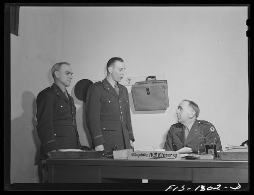 Untitled photo, possibly related to: Chaplains Martin J. Stein and Thadieth Son of Brownwood, Texas, saying goodbye to Chaplain William D. Cleary, Commandant of the U.S. Army chaplain school. Fort Benjamin Harrison, Indiana