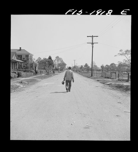 Newport News, Virginia. Negro shipyard worker leaving his rural home for the shipyards with his lunch box