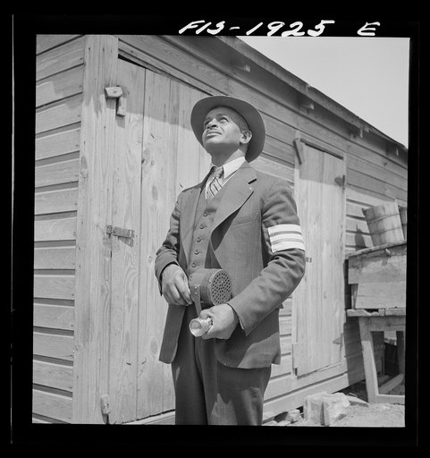 Untitled photo, possibly related to: Newport News, Virginia. Negro shipyard worker does volunteer duty as an air raid warden