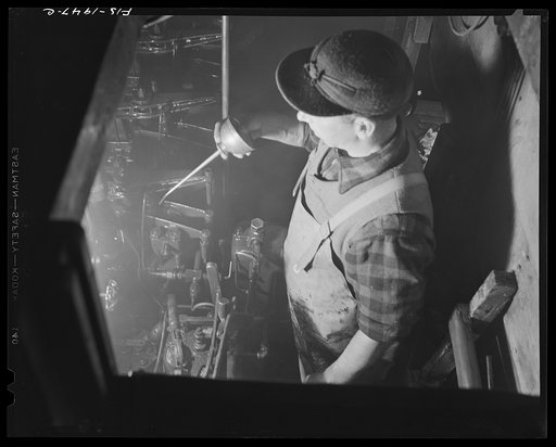 Provincetown, Massachusetts. Oiling the diesel engines aboard the Frances and Marion drag trawler
