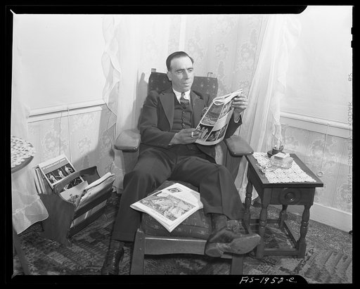 Provincetown, Massachusetts. John Russe, Jr., a Portuguese fisherman, reading at home on Sunday evening