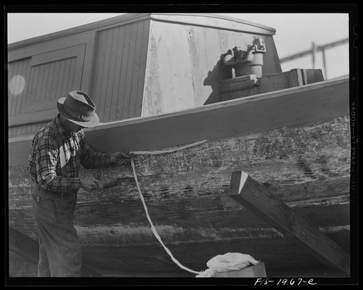 Provincetown. Massachusetts. Portuguese workmen caulking a hull