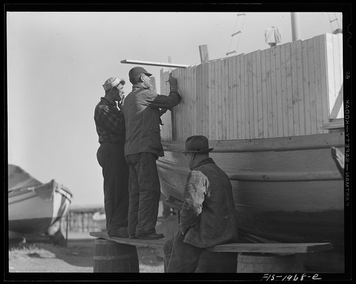 Provincetown, Massachusetts. Portuguese workmen building a cabin on an open dory