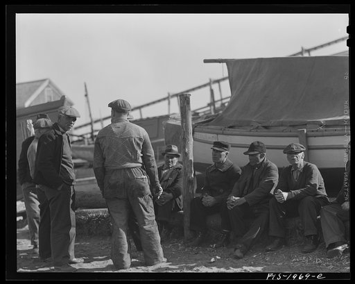Untitled photo, possibly related to: Provincetown, Massachusetts. Portuguese workmen building a cabin on an open dory