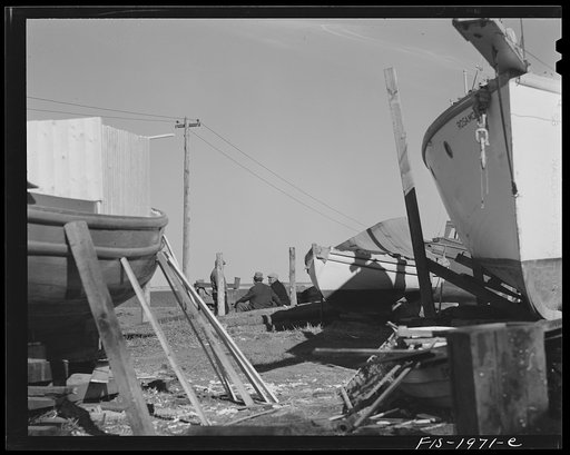 Untitled photo, possibly related to: Provincetown, Massachusetts. Portuguese workmen building a cabin on an open dory