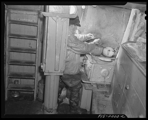 Untitled photo, possibly related to: Provincetown, Massachusetts. Getting breakfast aboard the Portuguese trawler, Frances and Marion