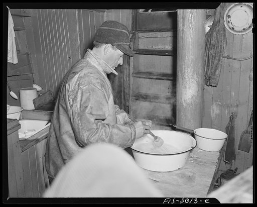 Untitled photo, possibly related to: Provincetown, Massachusetts. Getting breakfast aboard the Portuguese trawler, Frances and Marion