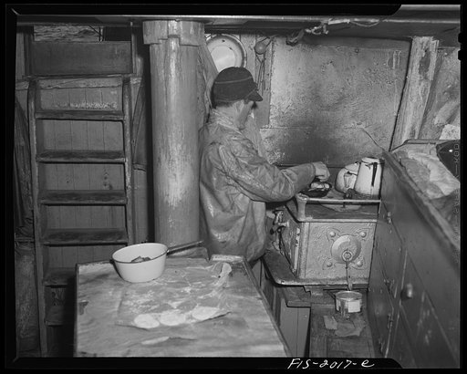 Untitled photo, possibly related to: Provincetown, Massachusetts. Getting breakfast aboard the Portuguese trawler, Frances and Marion