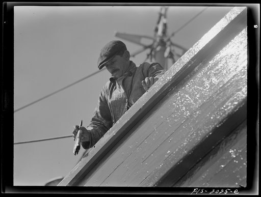 Untitled photo, possibly related to: Provincetown, Massachusetts. The crew of the Frances and Marion, a Portuguese trawler, painting ship on the beach