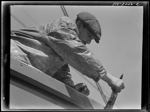 Untitled photo, possibly related to: Provincetown, Massachusetts. The crew of the Frances and Marion, a Portuguese trawler, painting ship on the beach