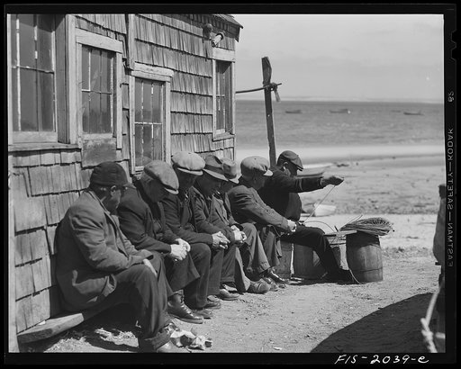 Provincetown, Massachusetts. Portuguese dory fishermen gossiping in the sun