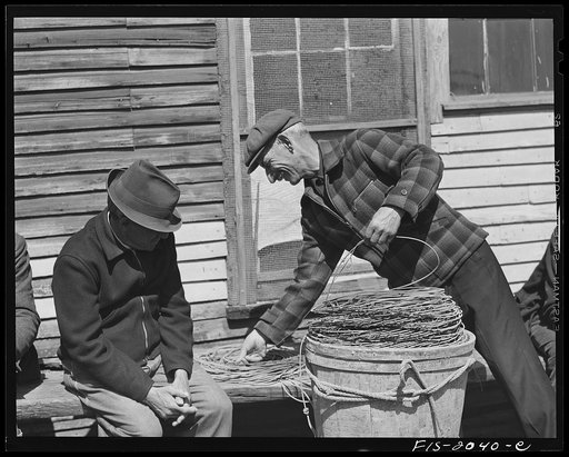 Provincetown, Massachusetts. Portuguese dory fisherman coiling down his trawl for the next day's fishing