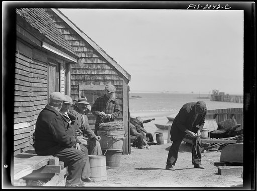 Untitled photo, possibly related to: Provincetown, Massachusetts. Portuguese dory fisherman coiling down his trawl for the next day's fishing