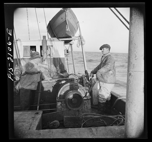 Provincetown, Massachusetts. Aboard the Frances and Marion, a Portuguese drag trawler, fishing off Cape Cod. Winchman hauling in the trawl