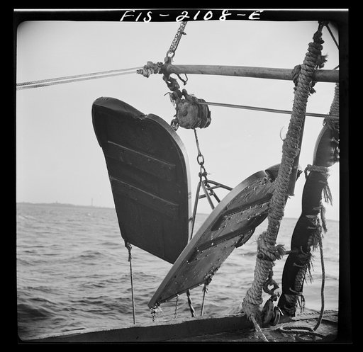 Provincetown, Massachusetts. Aboard the Frances and Marion, a Portuguese drag trawler, fishing off Cape Cod. "Doors," which when lowered, slide over the bed of the ocean like sled runners, dragging behind them the purse seine which scoops up miscellaneous fish, rocks, crabs, lobsters, and a great de