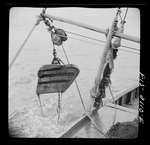 Untitled photo, possibly related to: Provincetown, Massachusetts. Aboard the Frances and Marion, a Portuguese drag trawler, fishing off Cape Cod. "Doors," which when lowered, slide over the bed of the ocean like sled runners, dragging behind them the purse seine which scoops up miscellaneous fish, r