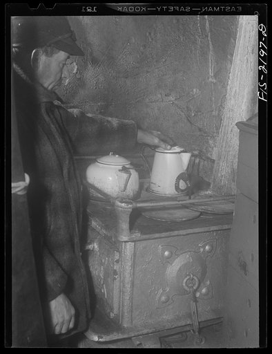 Untitled photo, possibly related to: Provincetown, Massachusetts. Getting breakfast aboard the Portuguese trawler Frances and Marion