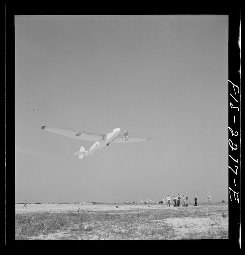 Untitled photo, possibly related to: Parris Island, South Carolina. A glider plane being towed over a a field at the U.S. Marine Corps glider detachment training camp