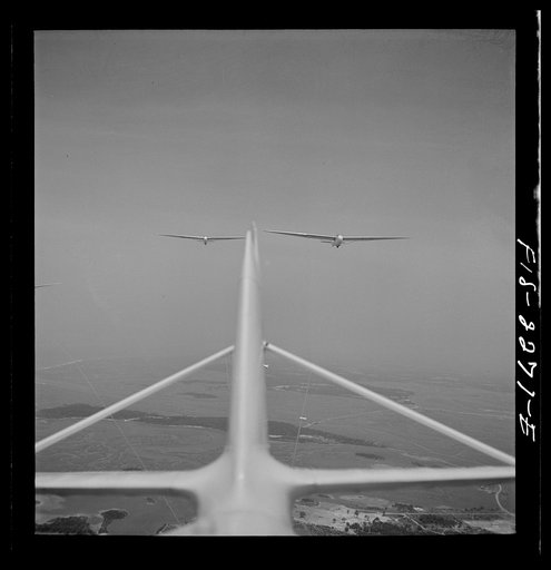 Untitled photo, possibly related to: Parris Island, South Carolina. U.S. Marine Corps glider detachment training camp. An aerial "tug boat" tows three gliders high above the field