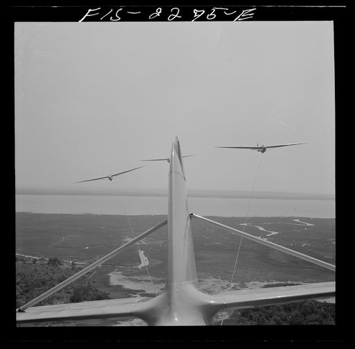 Untitled photo, possibly related to: Parris Island, South Carolina. U.S. Marine Corps glider detachment training camp. An aerial "tug boat" tows three gliders high above the field