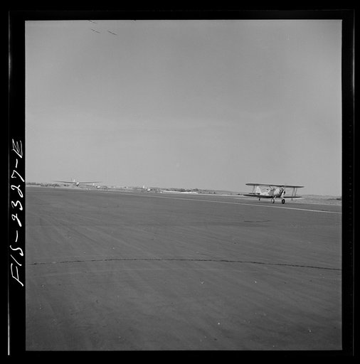 Untitled photo, possibly related to: Parris Island, South Carolina. An aerial "tug boat" towing three gliders across the field at the U.S. Marine Corps glider detachment training camp