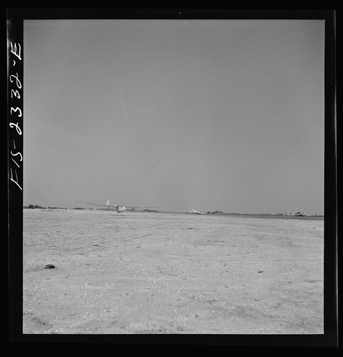 Untitled photo, possibly related to: Parris Island, South Carolina. A glider plane being towed over a field at the U.S. Marine Corps glider detachment training camp