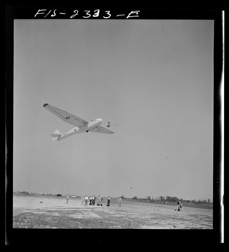 Parris Island, South Carolina. A glider plane being towed over a a field at the U.S. Marine Corps glider detachment training camp