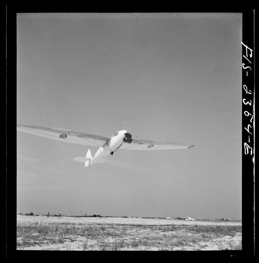 Untitled photo, possibly related to: Parris Island, South Carolina. A glider plane being towed over a field at the U.S. Marine Corps glider detachment training camp