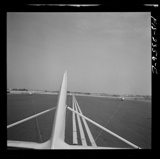 Untitled photo, possibly related to: Parris Island, South Carolina. U.S. Marine Corps glider detachment training camp. An aerial "tug boat" tows three gliders high above the field