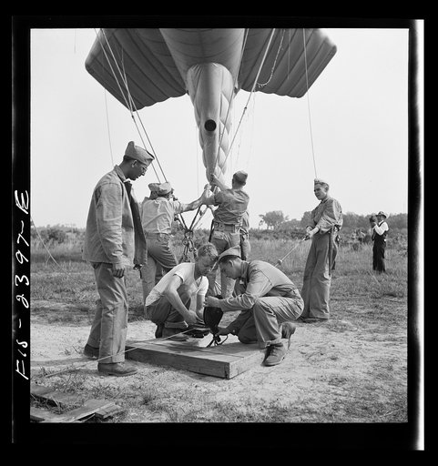 Parris Island, South Carolina. U.S. Marine Corps glider detachment training camp. Running up the barrage balloon into a tactical formation under control of a steelcable, a feature of technique at which the Marines at Parris Island must become proficient