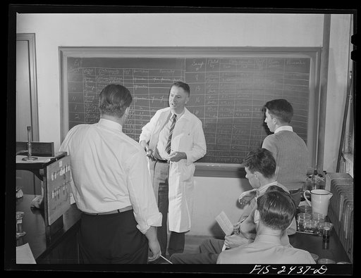 Professor M.P. Baker lecturing a senior class in bacteriology at Iowa State College. Ames, Iowa