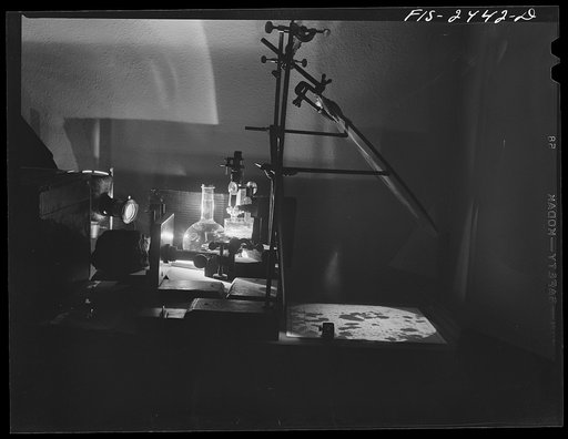 A micro-projector set up used by Professor Peterson of Soils and Agronomy Department for making a count of aggregates in studying soil structure. On the ruled paper on the right appears an image of soil particles magnified 100 times. Iowa State College, Ames, Iowa