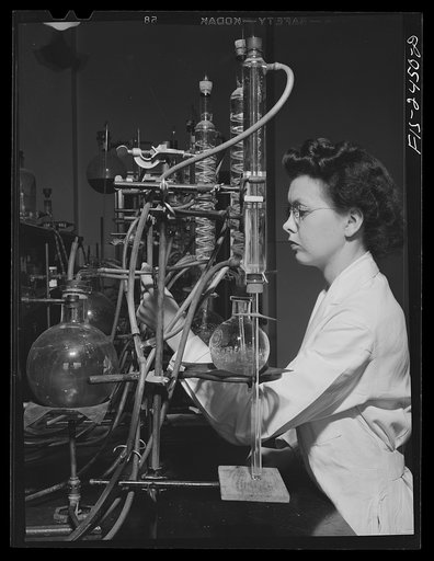 Miss Jeanne Dougherty, graduate in Bacteriology, working in the laboratory in the Dairy Industry Department. She is conducting experiments on the effects of acids on flavor of butter. Iowa State College. Ames, Iowa