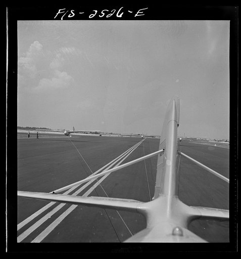 Untitled photo, possibly related to: Parris Island, South Carolina. U.S. Marine Corps glider detachment training camp. An aerial "tug boat" tows three gliders high above the field