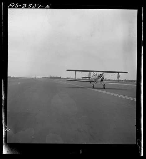 Untitled photo, possibly related to: Parris Island, South Carolina. An aerial "tug boat" towing three gliders across the field at the U.S. Marine Corps glider detachment training camp