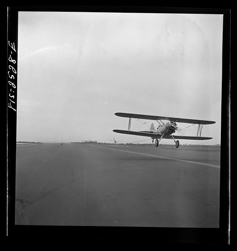 Untitled photo, possibly related to: Parris Island, South Carolina. An aerial "tug boat" towing three gliders across the field at the U.S. Marine Corps glider detachment training camp