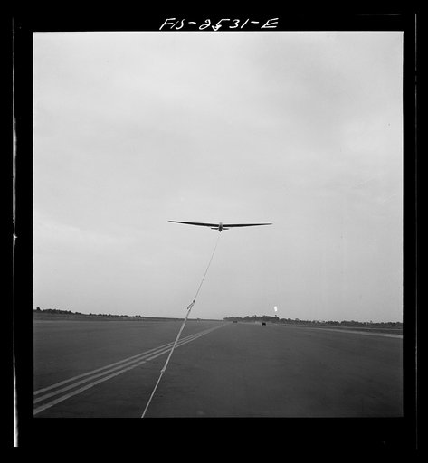 Untitled photo, possibly related to: Parris Island, South Carolina. U.S. Marine Corps glider detachment training camp. An aerial "tug boat" tows three gliders high above the field