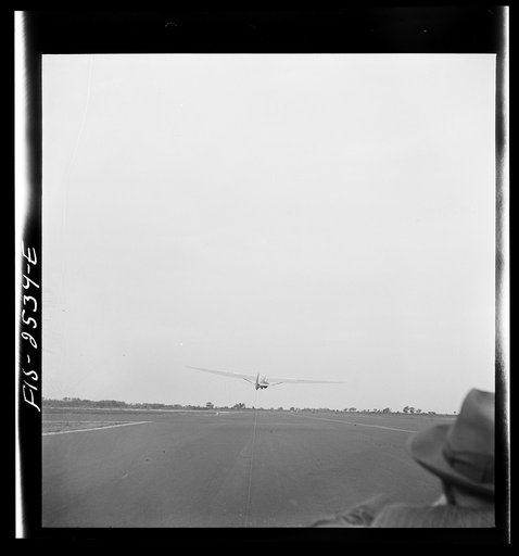 Untitled photo, possibly related to: Parris Island, South Carolina. U.S. Marine Corps glider detachment training camp. An aerial "tug boat" tows three gliders high above the field