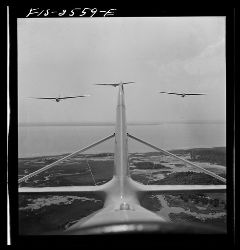 Untitled photo, possibly related to: Parris Island, South Carolina. U.S. Marine Corps glider detachment training camp. An aerial "tug boat" tows three gliders high above the field