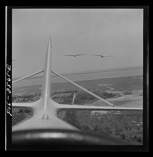Untitled photo, possibly related to: Parris Island, South Carolina. U.S. Marine Corps glider detachment training camp. An aerial "tug boat" tows three gliders high above the field