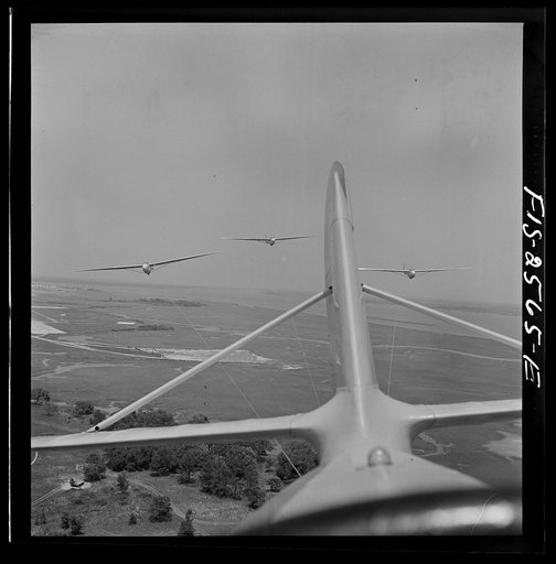 Untitled photo, possibly related to: Parris Island, South Carolina. U.S. Marine Corps glider detachment training camp. An aerial "tug boat" tows three gliders high above the field