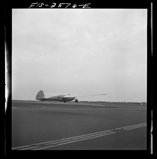 Parris Island, South Carolina. A glider plane being towed over a field at the U.S. Marine Corps glider detachment training camp