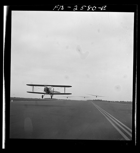 Parris Island, South Carolina. An aerial "tug boat" towing three gliders across the field at the U.S. Marine Corps glider detachment training camp