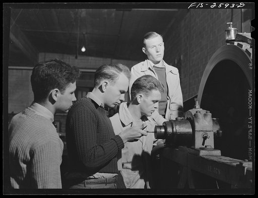 Group of students in agricultural engineering conducting a brake test on a power machine. In agriculture engineering building. Iowa State College, Ames, Iowa