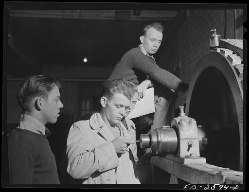 Untitled photo, possibly related to: Group of students in agricultural engineering conducting a brake test on a power machine. In agriculture engineering building. Iowa State College, Ames, Iowa