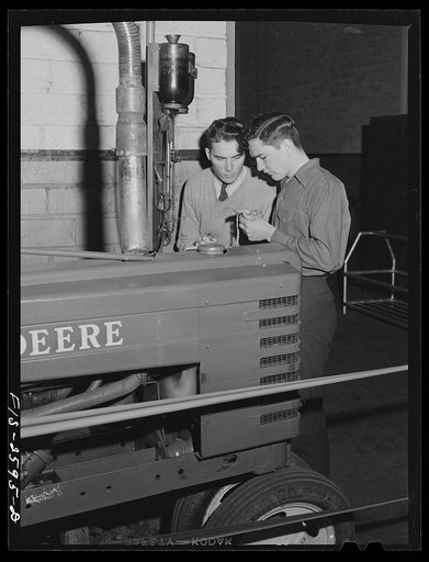 William Shold and Fred Wentworth checking gas consumption of a tractor during a brake test experiment. Iowa State College. Ames, Iowa